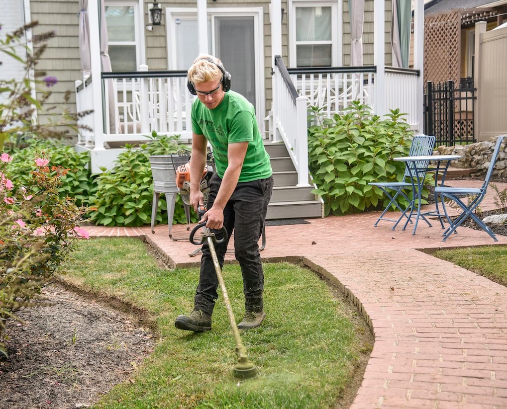 A man cleaning up outdoor living space